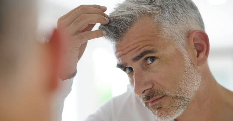 Why does hair turn white with age?
