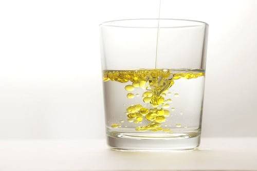 Why does oil float on water?